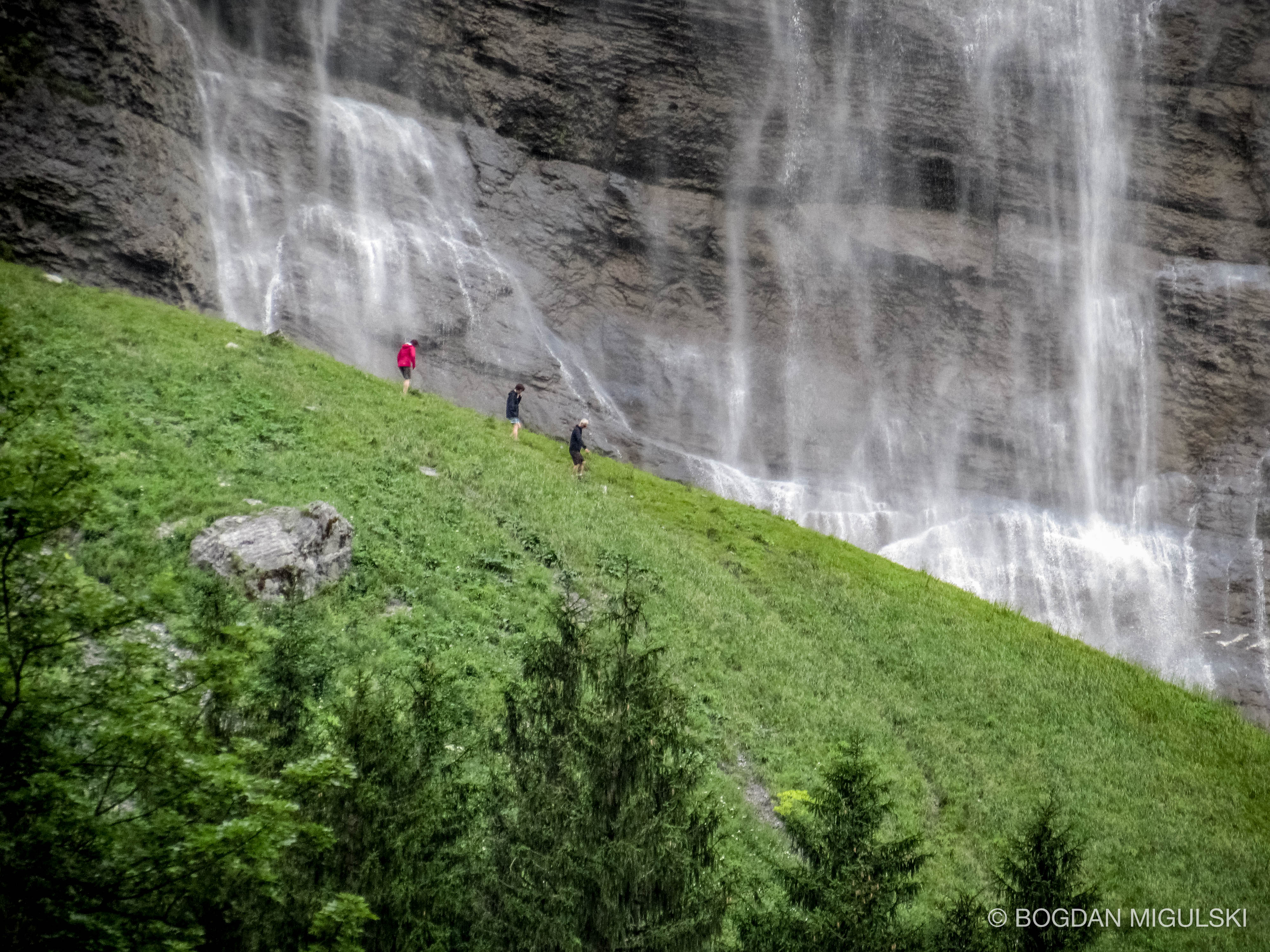 People Passing Waterfalls in the Lauterbrunnen Valley