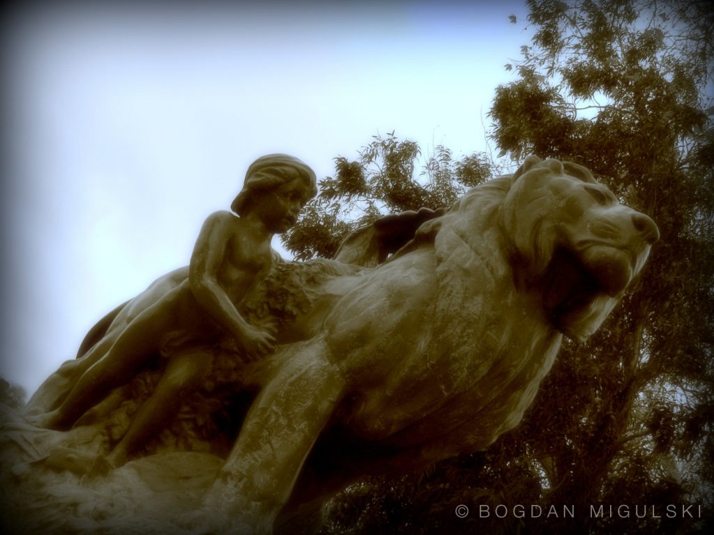 Boy Riding Lion Sculpture in El Retiro Park, Madrid, Spain.